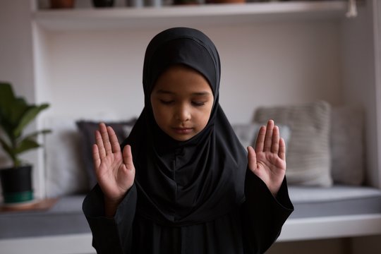 Muslim girl praying salah at home