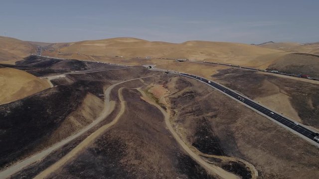 Aerial footage of a 650 acre fire started in the Altamont hills between Tracy and Livermore in California.
