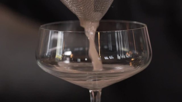 Close up of Cocktail being poured into glass.