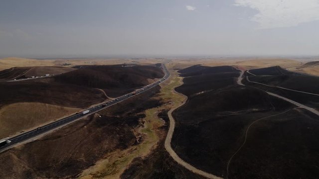 Aerial footage of a 650 acre fire started in the Altamont hills between Tracy and Livermore in California.