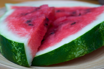 Watermelon flesh on a wooden plate
