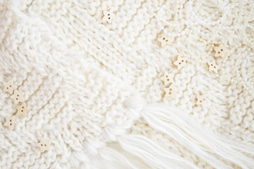 Knitted wool carpet close-up, star buttons. Textile texture. Natural woolen fabric