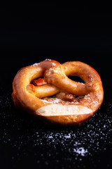 Homemade twisted knot Soft salt Pretzels on black slate board background