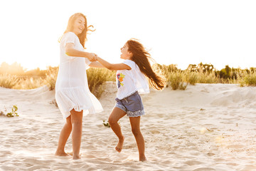 Cute family having fun together outdoors at the beach.