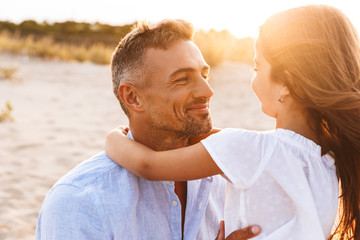 Cute family having fun together outdoors at the beach.