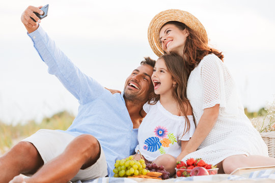 Happy family having fun together make selfie by mobile phone.