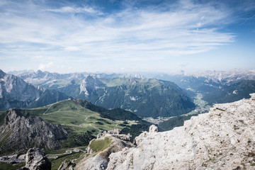 Fototapeta na wymiar View of the Val di Fassa valley and Dolomites mountain - UNESCO heritage - from the top of the Sass Pordoi, Canazei.