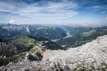 Fototapeta na wymiar View of the Val di Fassa valley and Dolomites mountain - UNESCO heritage - from the top of the Sass Pordoi, Canazei.
