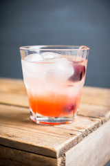 Old fashioned cocktail with cherry. Selective focus.