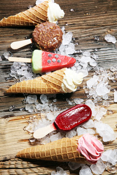 ice cream in waffle cone and strawberry, raspberry and chocolate softice cream and colorful popsicle