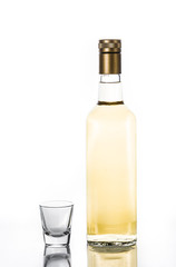 Mexican Gold tequila bottle and glass isolated on white background

