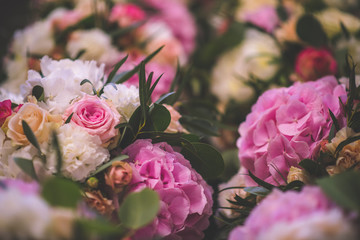 Wedding table with exclusive floral arrangement prepared for reception, wedding or event centerpiece in romantic pink style