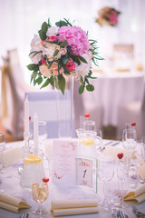Wedding table with exclusive floral arrangement prepared for reception, wedding or event centerpiece in romantic pink style