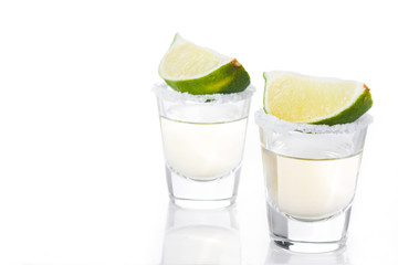 Mexican Gold tequila with lime and salt isolated on white background. Copyspace


