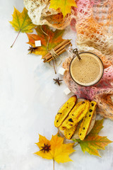 Autumn background baking. Freshly baked raisins and cinnamon biscotti and a cup of cappuccino coffee on light slate or slate background. Top view flat lay background, copy space.