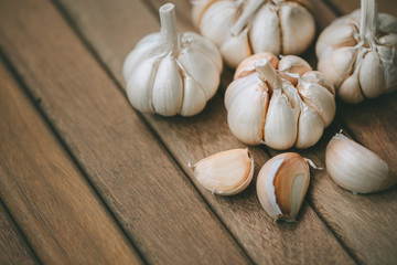 Garlic and cloves upper right corner on wooden background