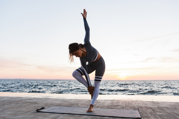 Portrait of a pretty young woman doing yoga exercises