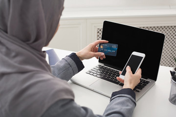 Mislim woman shopping online with smartphone