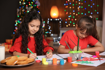 Fototapeta premium Little children drawing pictures at home. Christmas celebration