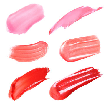 Makeup product smears on white background. Color set of lip glosses and lipsticks