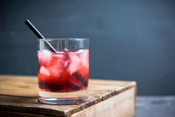 Old fashioned cocktail with cherry. Selective focus.