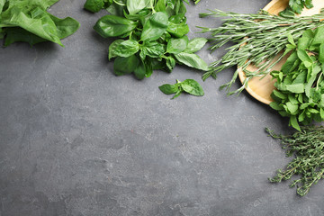 Flat lay composition with fresh green herbs on grey background