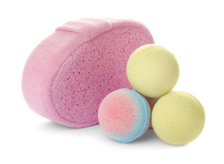 Pink sponge and bath bombs on white background