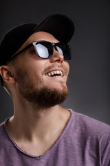Obraz premium young bearded man in cap and sunglasses