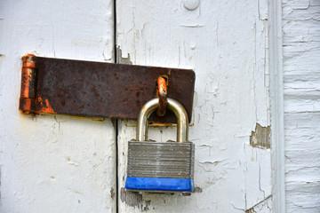 Rusted Oil Padlock and Weathered Door Abstract