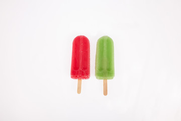 two tasty and refreshing popsicles on white background