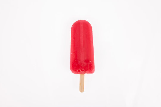 Tasty and refreshing popsicles on white background