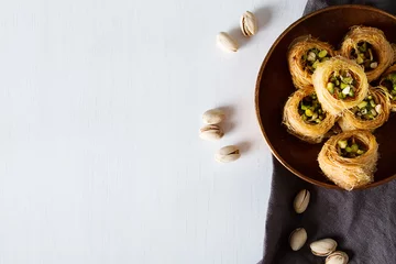 Deurstickers Traditional arabic dessert baklava with pistachios. White background © naltik