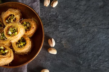 Foto op Plexiglas Traditionele Arabische dessertbaklava met pistachenoten. Donkere achtergrond © naltik