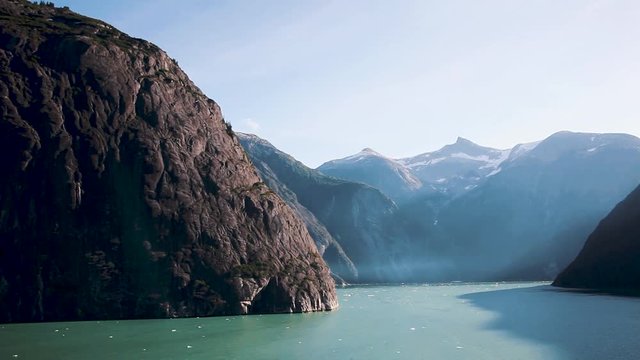 Sunny sky highlights the stunning scenery of Tracy Arm Fjord near Juneau, Alaska. Untamed, natural wilderness and wildlife with incredible landscape. Slow motion.