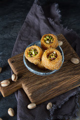 Traditional arabic dessert baklava with pistachios. Dark background