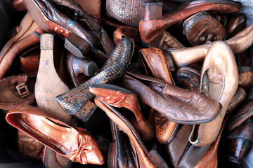 Old weathered shoes dump. Footwear collection mountain.