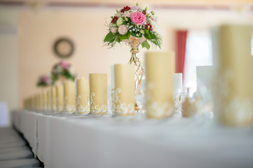Wedding table with exclusive floral arrangement prepared for reception, wedding or event centerpiece in romantic gold style