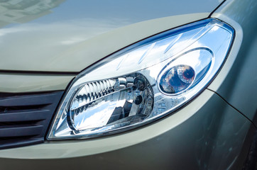 Car head light gray green in the street