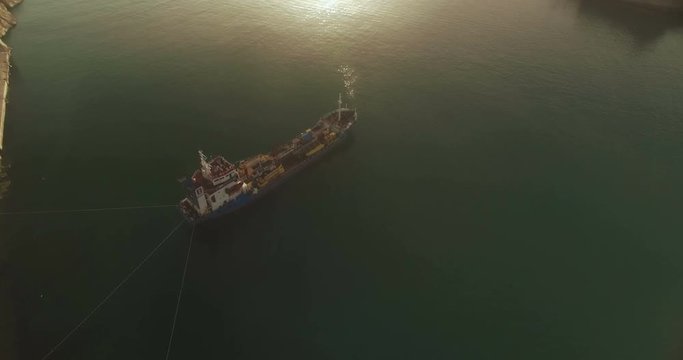 Aerial Shot over an anchored containers ship in a harbor
