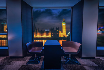 Modern living room with view Big Ben at night in Landon, UK.
