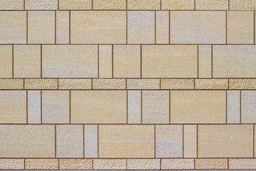 Naklejka premium Modern stone tile wall background with a marble looking beige stones arranged in a stained glass style