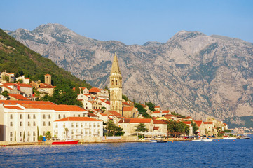 Fototapeta na wymiar View of the ancient town of Perast with the bell tower of the church of St. Nicholas. Montenegro, Bay of Kotor