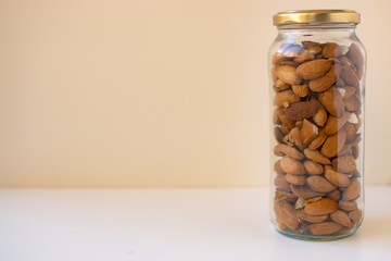 Almonds freshly caught in two cans with white background.