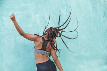 attractive black dancer moving her braids - obrazy, fototapety, plakaty