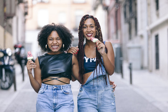 Cheerful Group Of Girlfriends Enjoying A Watermelon Ice Cream