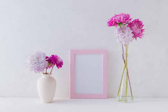 Mockup with a pink frame and pink flowers in a vase