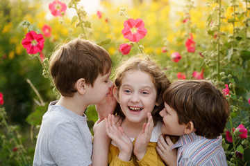 Fototapeta premium Cute children whispers in summer outdoors.