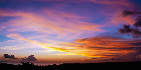 Sunset scene colorful clouds and sky dusk time in Tobago sea on the far away horizon