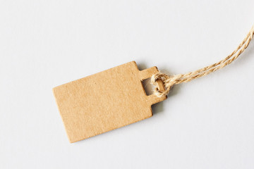 Blank brown cardboard price tag, sale tag, gift tag, address label on white background