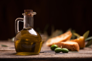 Olive oil with bread on a wooden table.